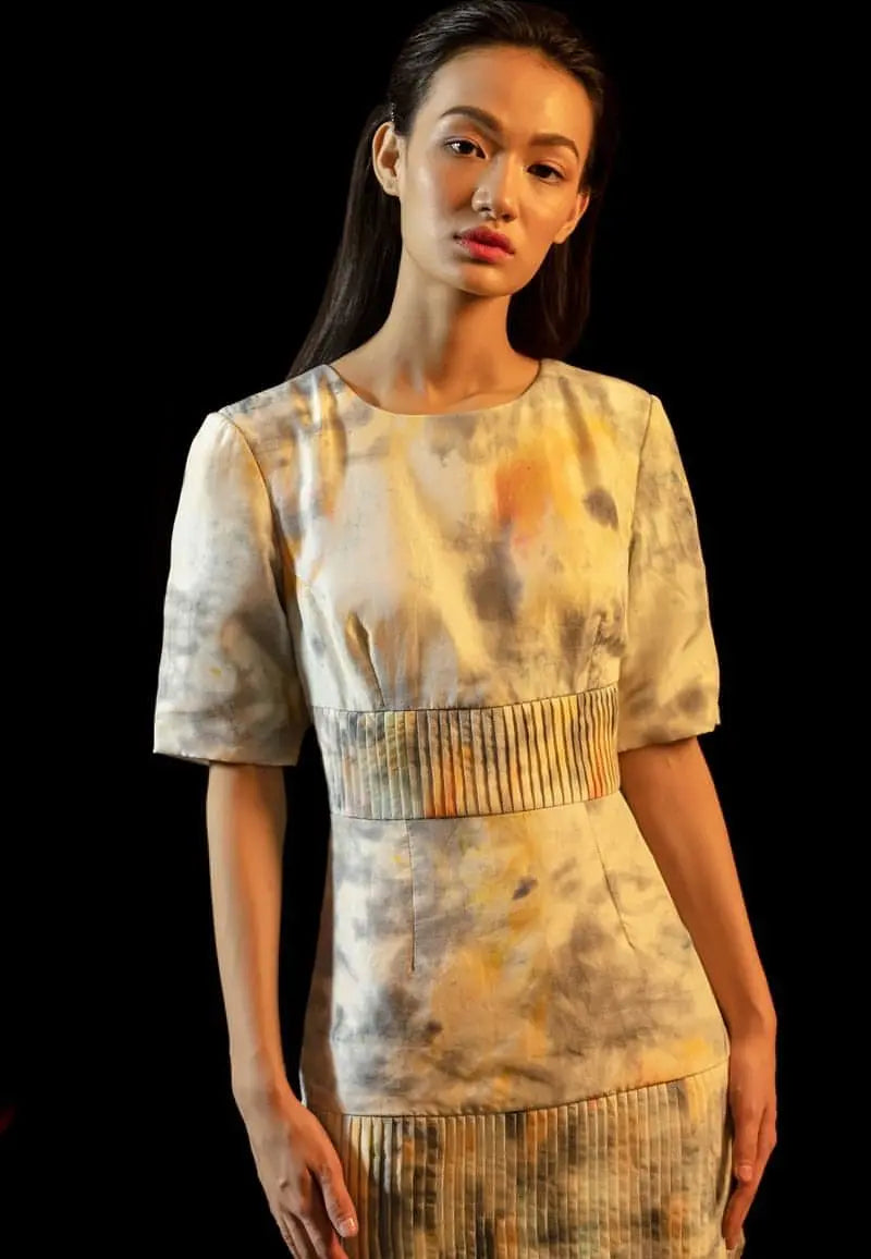 Shoulder-padded pleated dress in yellow