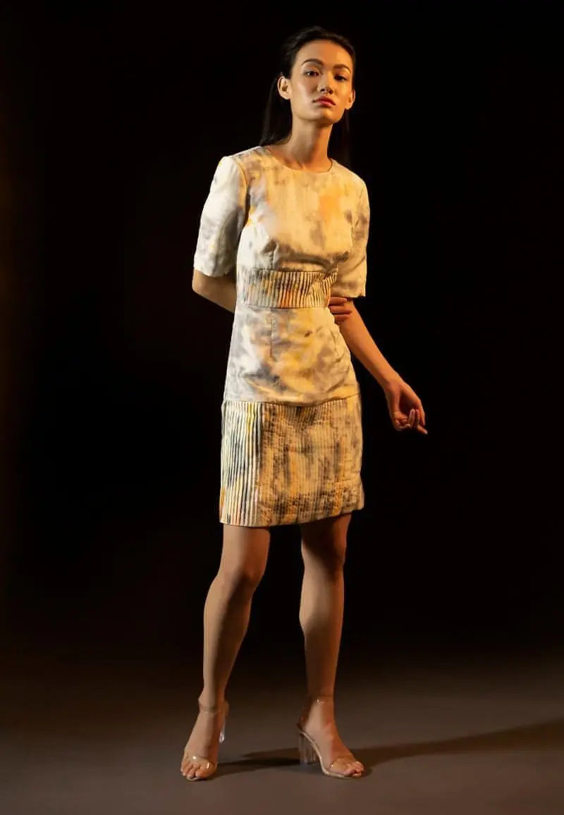 Shoulder-padded pleated dress in yellow